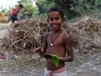 A boy eating Gur (jaggery) in a village on December 10, 2021 in Barpeta, Assam, India. Gur (jaggery) is a natural product of sugarcane, make...