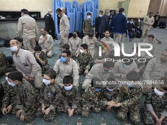Iranian young boys in military uniforms and members of the Islamic Revolutionary Guard Corps (IRGC) wait to perform in a death anniversary f...