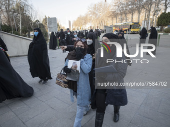 An Iranian woman carrying a portrait of the Iranian top IRGC commander, General Qasem Soleimani who was killed in a U.S. drone attack in Bag...