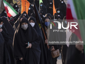 Iranian veiled women carrying Iran flags while arriving the Azadi (Freedom) sport complex to attend a death anniversary of the Iranian top I...