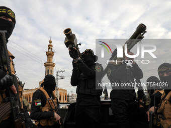 Palestinian members of the Al-Quds Brigades, the military wing of the Islamic Jihad group, march with their rifles along the main road of Ga...