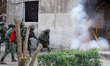 Soldiers ignite a device for door explosion, during an Army Preparedness Enhancement Drill...