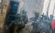 Soldiers break a door for an assault against enemies , during an Army Preparedness Enhance...