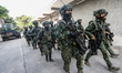 Soldiers with machine guns in procession near a CM-34 armored vehicle, during an Army Prep...