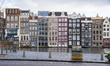 The empty canals of Amsterdam with the tourist sightseeing boats docked. Quiet, almost des...