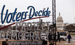 The sign for acandlelight vigil in remembrance of the January 6 insurrection stands on the...