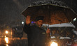 A cop manages the traffic as it snows in Srinagar on January 07, 2022.The weather departm...