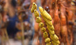 An assamese woman selling roasted silkworm moth and other roasted meat during a Bhogali Me...