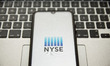 In this photo illustration a NYSE Euronext logo seen displayed on a smartphone screen with...
