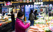 A lady prepares to purchase fresh vegetables in a wet market in Kai yip estate, in Hong Ko...