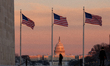 People watch a beautiful sunset over the Capitol from the Washington Monument after an une...