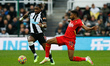 Allan Saint-Maximin of Newcastle United and Emmanuel Dennis of Watford in action during th...