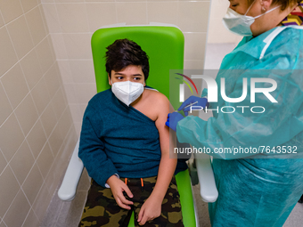 A boy gets the vaccine injected by a nurse during the night dedicated to 12-19 year olds at the Cozzoli vaccination hub in Molfetta on Janua...