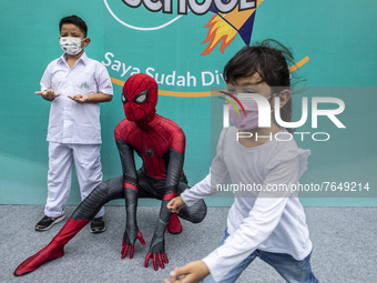 A student poses with a spiderman character after being vaccinated in South Tangerang, Banten, Indonesia on 17 January 2022. Indonesia is pre...