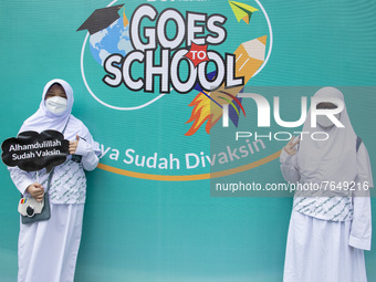 Two students pose after getting the COVID-19 vaccine in South Tangerang, Banten, Indonesia on 17 January 2022. Indonesia is preparing to fac...