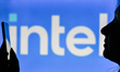 An image of a woman holding a cell phone in front of the INTEL logo displayed on a compute...