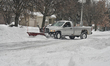 Snowplow clears the snow from a driveway in front of a home as a massive snowstorm hit Tor...