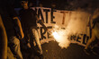 A housing rights activist lights a flare as he  take part in a demonstration to protest ag...