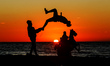 A Palestinian youth practice his parkour skills in the beach of Gaza City during Sunset, o...