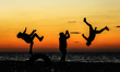 Palestinian youthes practice their parkour skills in the beach of Gaza City during Sunset,...