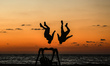 Palestinian youthes practice their parkour skills in the beach of Gaza City during Sunset,...
