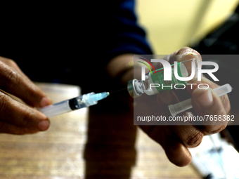 A health worker fills a syringe with 'Covishield' COVID-19 vaccine inside a health center in Kolkata, India , on January 19, 2022.  (