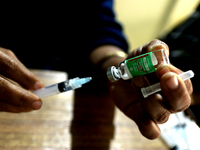 A health worker fills a syringe with 'Covishield' COVID-19 vaccine inside a health center in Kolkata, India , on January 19, 2022.  (