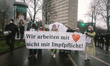 the banner of " we work only no mandatory of vaccination " is seen during the anti vaxxers...
