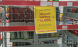 Placard with the words 'Government Program Cooking Oil Price' on an empty cooking oil disp...