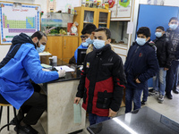 Palestinian students wait to receive a dose of the Pfizer-BioNTech vaccine against COVID-19 during a vaccination campaigat a school of the U...