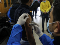 Palestinian students of the UN Relief and Works Agency (UNRWA) receive a dose of the Pfizer-BioNTech vaccine against COVID-19 during a vacci...