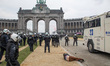 Police officers in Jubelpark with the Arcades du Cinquantenaire - Triumph Arch while a pro...