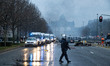 A police officer walks on the empty road in Brussels. Thousands Protest during the Europea...