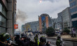Protesters throw a flare against the police. Thousands Protest during the European Demonst...