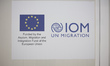 A sign with the IOM UN MIGRATION logo. Inside the new Refugee camp in Samos island that ha...