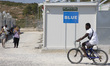 A man is cycling a bike in the camp at the BLUE zone. Inside the new Refugee camp in Samos...