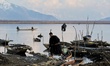 A kashmiri man walks back after completing his work at Wular Lake in Sopore, District Bara...