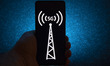 Photo illustration of a 5G signal from an antenna symbol logo displayed on a smartphone di...