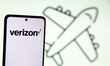 Photo illustration of a the Verizon logo and an airplane illustration, symbol for travel a...