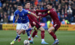 Oldham Athletic's Alex Hunt tussles with Corey O'Keeffe of Rochdale Association Football C...
