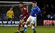 Oldham Athletic's Harrison McGahey tussles with Tahvon Campbell of Rochdale Association Fo...