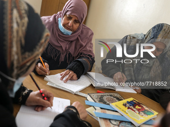 Elderly Palestinian women receive literacy lessons inside the Aged Care Association, in Gaza City, Feb. 2, 2022.  (