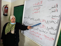 Elderly Palestinian women receive literacy lessons inside the Aged Care Association, in Gaza City, Feb. 2, 2022.  (
