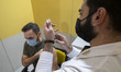 An Iranian medical personnel loads a syringe with the South Korea AstraZeneca new coronavi...