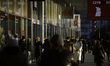 A couple wearing a face masks is seen near a shopping boulevard in the center of Warsaw, P...