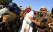 Jaipur: Police personnel try to stop BJP leader Kirodi Lal Meena and other activists, duri...