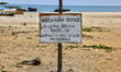 Sign warning that 'going to the sea is prohibited' along the beach where the Battle of Mul...