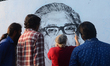 Bangladeshi fine arts students painting on a wall in front of the Shaheed Minar, the Langu...