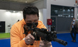 A visitor checks a semi-automatic rifle at the SICUR 2022 International Security Show that...