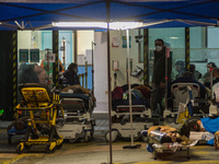 COVID Patients are placed on hospital beds outside the Accident & Emergency ward of Caritas Medical Centre, in Hong Kong, China, on February...